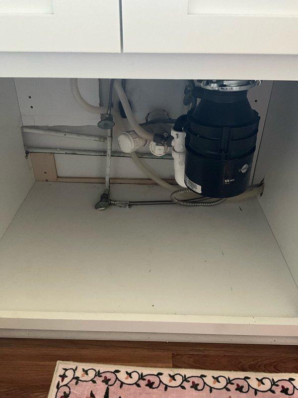Responded to service call for leaking garbage disposal unit. Upon inspection, identified leak at discharge connection point where disposal unit connects to drain line. Removed and cleaned existing connection, replaced worn gasket and discharge elbow fitting, and reinstalled with proper sealant. Tested disposal operation and verified all connections are secure with no active leaks present.