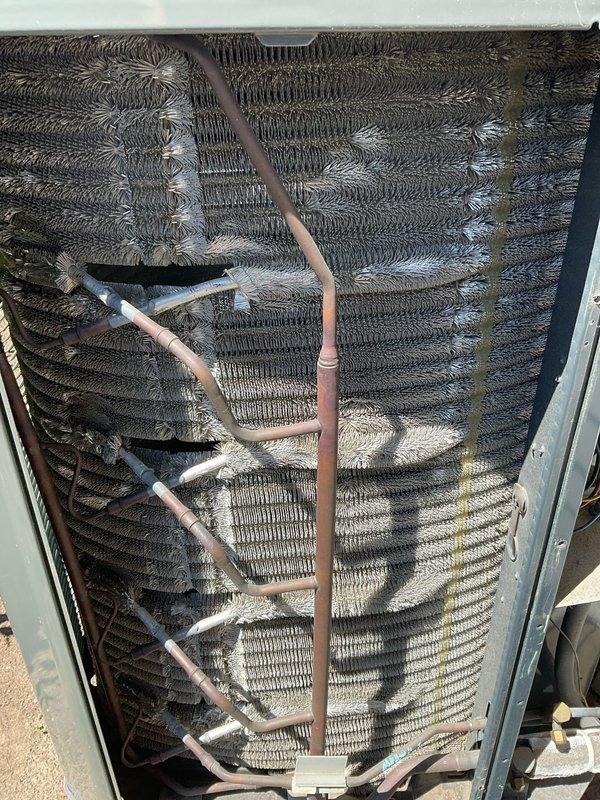 Completed comprehensive BFMA tune-up service on 5+ year old air conditioning system. Performed full system inspection, replaced air filter, and evaluated condenser coil which showed moderate to heavy accumulation of dirt, dust, and environmental debris on heat exchanger fins. Condenser unit exterior coils displayed significant contamination affecting heat transfer efficiency, with visible buildup throughout the corrugated fin assembly. Inspected refrigerant lines and insulation for proper condition. System operational upon completion of preventative maintenance procedures.