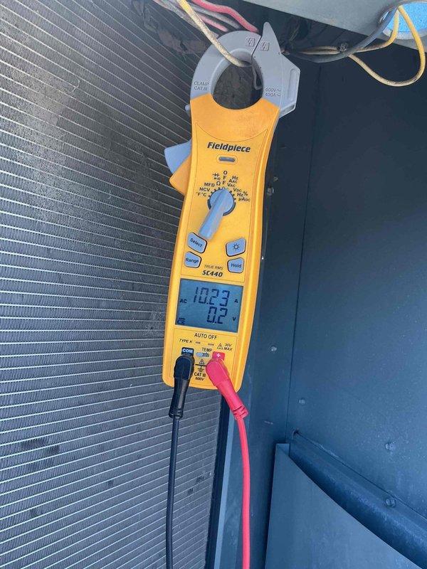 Responded to commercial no cooling call on rooftop unit. Upon arrival, verified unit was not operating. Performed electrical diagnostics using clamp meter to check amperage draws and voltage at contactor assembly. Measured 93.2A and 102.3A readings during testing sequence. Inspected control panel wiring, contactors, and associated electrical components. Condenser coil found in clean condition with no airflow restrictions. Identified issue with electrical control circuit preventing unit startup. Restored unit to normal operation and verified proper amperage and cooling cycle.