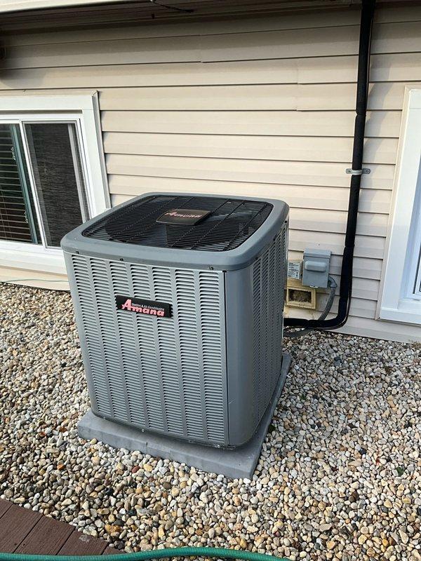 Completed comprehensive BFMA tune-up service on residential Amana air conditioning system. Performed full system inspection of outdoor condensing unit, including cleaning of condenser coil which showed moderate accumulation of dirt and debris. Evaluated electrical connections at disconnect box, verified proper refrigerant levels, tested compressor operation, and inspected conduit mounting. Filter assembly exhibited significant particulate buildup and contamination across mesh surface, with heavier accumulation noted on one side indicating restricted airflow. Cleaned accessible components, confirmed unit operational parameters within manufacturer specifications, and verified system cycling properly. Equipment positioned on gravel pad with adequate drainage and clearance from structure.