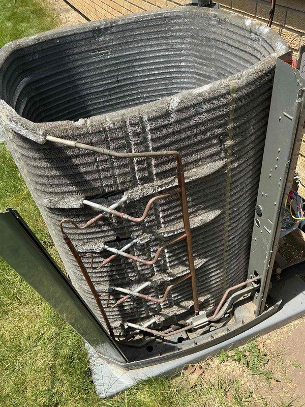 Completed comprehensive BFMA tune-up service on outdoor air conditioning condenser unit over 4 years old. Performed thorough inspection of cylindrical condenser coil assembly, copper refrigerant lines, and all mechanical components. Cleaned accumulated dirt and debris from horizontal coil fins, verified refrigerant line connections, checked electrical components and access panels, and ensured proper drainage system function. Unit tested and confirmed operational upon service completion.