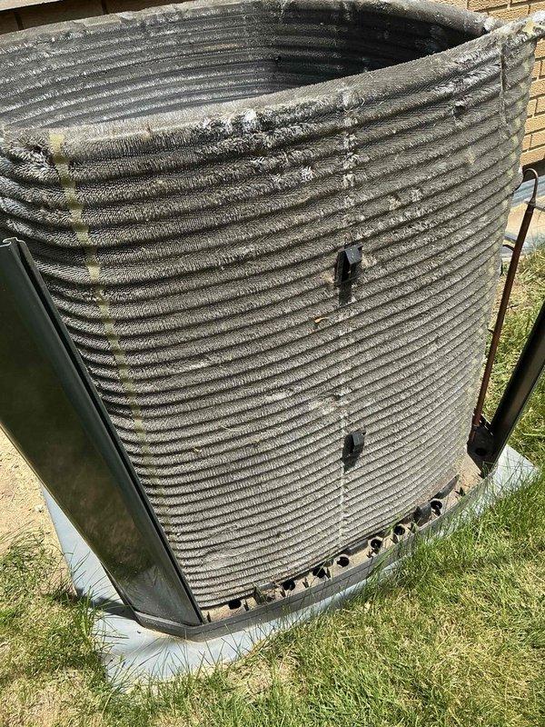 Completed comprehensive BFMA tune-up service on outdoor air conditioning condenser unit over 4 years old. Performed thorough inspection of cylindrical condenser coil assembly, copper refrigerant lines, and all mechanical components. Cleaned accumulated dirt and debris from horizontal coil fins, verified refrigerant line connections, checked electrical components and access panels, and ensured proper drainage system function. Unit tested and confirmed operational upon service completion.