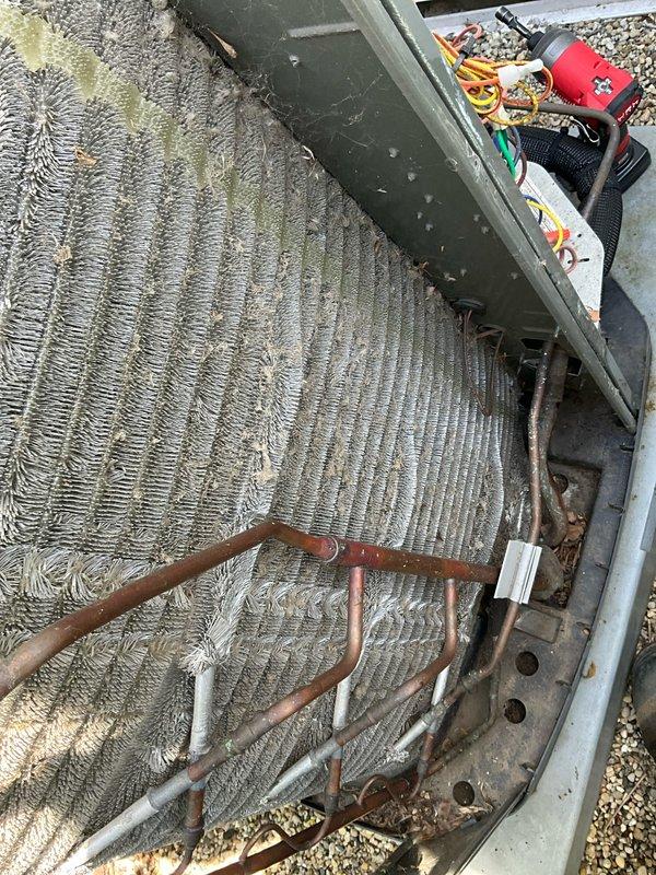 Completed comprehensive BFMA tune-up service on outdoor air conditioning unit aged 2+ years. Upon inspection, found evaporator coil heavily clogged with dust, dirt, and organic debris significantly restricting airflow and reducing system efficiency. Performed thorough coil cleaning to remove accumulated particulate matter from aluminum fins, cleared debris from unit interior, inspected refrigerant lines and electrical connections, and replaced air filter per maintenance protocol. System restored to optimal operating condition with improved airflow and efficiency.