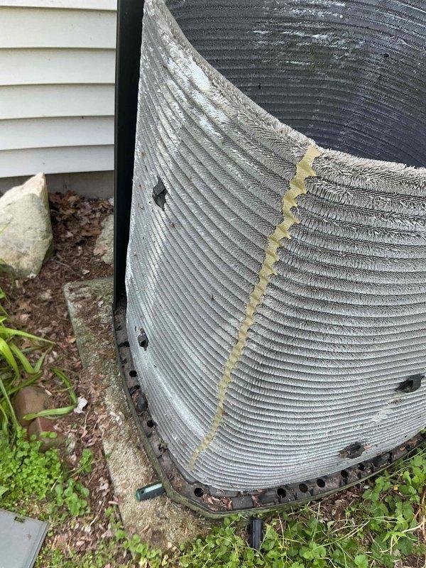 Completed comprehensive BFMA tune-up service on 10-year-old residential HVAC system including air conditioning unit, dryer vent, and dehumidifier. Performed thorough inspection of outdoor condenser unit with cylindrical design and ribbed aluminum fins, noting minor debris accumulation between fin ridges and deteriorated foam insulation on vertical section. Inspected internal components including Genteq motor (model D147088P02, 440VAC), verified electrical connections on multi-colored wiring harnesses, and examined relay components for proper operation. Cleaned condenser coils, cleared drainage pathways in base pan, and removed organic debris from surrounding area. All equipment operating within normal parameters upon completion of maintenance protocol.