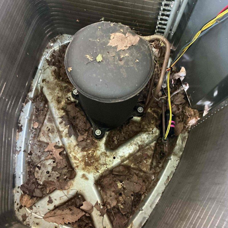 Completed comprehensive BFMA tune-up on residential air conditioning unit aged 1+ years. Upon arrival, performed thorough inspection revealing significant debris accumulation including dried leaves and organic matter throughout unit interior, along with extensive rust and corrosion on metal housing and base plate. Cleaned condenser coil fins and removed all debris from unit. Tested electrical components using digital multimeter to verify proper voltage and amperage readings on capacitor and compressor system. Inspected all wiring connections and verified system operation. Unit running within manufacturer specifications following service completion.