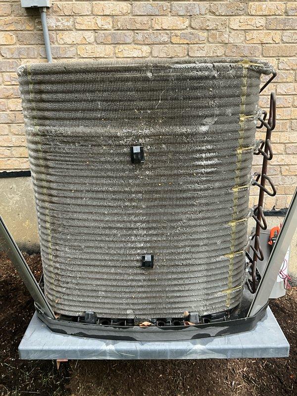 Completed comprehensive BFMA tune-up on 7+ year old outdoor condenser unit. Upon arrival, found heat exchanger coils heavily caked with dirt, dust, lint, and organic debris throughout the fin assembly, significantly restricting airflow and reducing system efficiency. Performed thorough coil cleaning to remove accumulated contaminants from all exterior surfaces and between fin spaces, restoring proper heat transfer capability. Inspected refrigerant lines, electrical connections, and mounting hardware. Unit now operating within normal parameters with improved airflow and heat exchange efficiency.