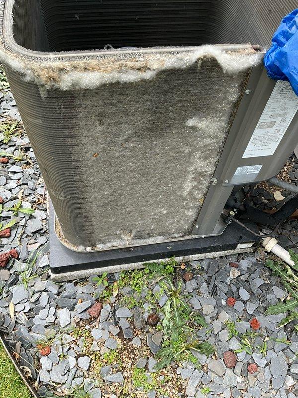 Completed spring maintenance tune-up on residential air conditioning system. Performed comprehensive inspection of outdoor condenser unit, which showed signs of age with visible dirt accumulation, debris buildup on coil fins, and whitish residue on metal surfaces. Cleaned condenser coils to remove environmental debris, dust, and lint accumulation from fin surfaces and front panel. Inspected refrigerant lines and electrical connections for proper condition. Verified unit operation and system functionality following maintenance procedures.
