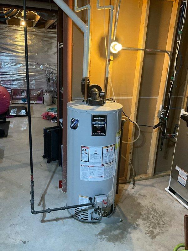 Responded to service call for leaking tanked water heater in residential basement utility room. Upon arrival, inspected 10-year-old water heater unit and identified active leak requiring attention. Assessed all plumbing connections, pressure relief valve, and discharge piping at top of unit. Documented existing conditions including water staining on concrete floor and evaluated overall system integrity. Provided recommendations for repair or replacement based on age of equipment and current condition of unit.