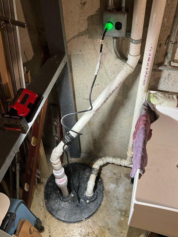 Removed and disposed of existing sump pump and check valve from basement sump pit. Installed new 1/2 horsepower Zoeller sump pump with fresh check valve, securing all PVC discharge piping with proper straps and connections. System tested and verified operational with 3-year warranty on pump and 1-year parts and labor warranty provided.