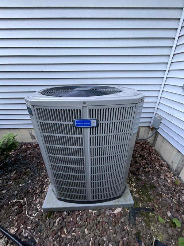 Completed comprehensive BFMA tune-up on 3-year-old residential air conditioning system during late afternoon service call. Upon arrival, performed standard maintenance inspection of outdoor condenser unit, removed protective casing to access internal components, and discovered significant frost and ice accumulation on cylindrical condenser coil assembly indicating potential refrigeration cycle issues or improper system operation. Documented unit condition with photographic evidence showing extensive crystalline frost buildup obscuring metal fins and coil surfaces, cleaned and serviced accessible components, verified unit positioning on concrete pad with proper clearances from vinyl siding, and ensured system readiness for continued operation.
