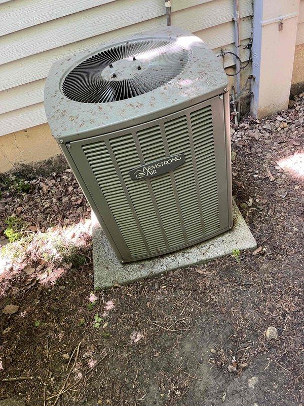 Completed comprehensive BFMA tune-up service on an 8-year-old Armstrong Air condensing unit and water heater system. Performed thorough inspection of outdoor condenser unit, which exhibited significant dirt and debris accumulation on coil fins and heat exchanger surfaces, particularly in middle and lower sections. Cleaned condenser coils to restore proper airflow and heat transfer efficiency, removing caked-on dust, dirt, and organic debris that had accumulated between fins. Inspected fan motor assembly, electrical connections, and refrigerant lines running along exterior wall. Verified proper operation of condenser fan and checked top-mounted fan guard for secure installation. Assessed unit's exterior condition, noting weathering consistent with outdoor exposure on concrete pad. Performed standard maintenance procedures on water heater system per BFMA protocol. All equipment operational upon completion of tune-up service.