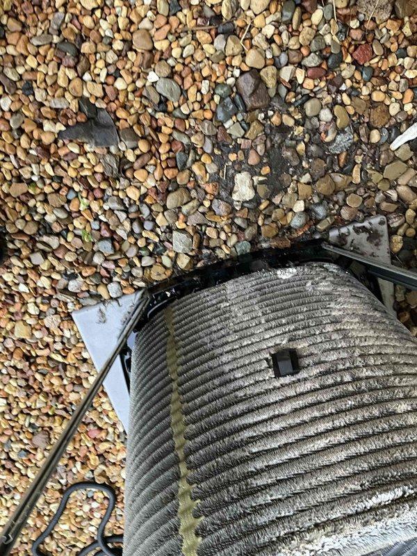 Completed comprehensive BFMA tune-up service on outdoor air conditioning unit aged 10+ years. Inspected condenser coil showing significant dust accumulation, mineral deposits, and minor algae growth on exterior surfaces; noted weathering consistent with unit age. Performed standard maintenance procedures including system inspection, measurement documentation, and photographic record of equipment condition for service history.