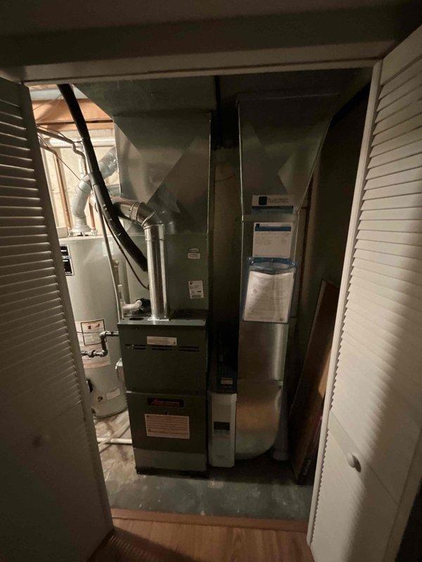 Completed comprehensive BFMA tune-up on residential air conditioning system aged 4+ years, located in utility closet alongside furnace and water heater. Performed full system diagnostics and measurements including return air dry bulb at 68.6°F, supply air dry bulb at 49.1°F, achieving proper temperature split of 19.5°F across evaporator coil. Verified target evaporator exit temperature at 50.8°F with supply relative humidity reading at 80.0% and return relative humidity at 46.1%, confirming adequate dehumidification performance. System operating within manufacturer specifications with no deficiencies noted.