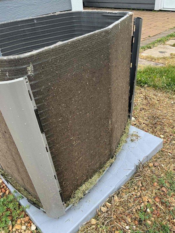 Completed comprehensive BFMA tune-up service on residential Lennox air conditioning system. Upon arrival, found outdoor condenser unit with heavily soiled exterior filter material showing significant accumulation of dirt, dust, debris, and algae growth along base edges, indicating extended period without maintenance. Performed complete AC tune-up protocol including cleaning of condenser coils and exterior surfaces, inspection of refrigerant lines and electrical connections, and verification of proper system operation. Unit now operating within manufacturer specifications with improved airflow efficiency.