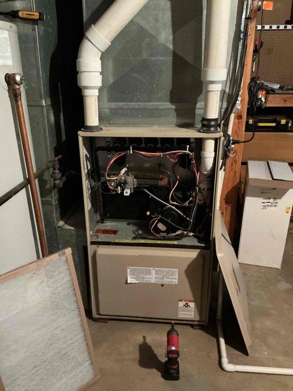 Completed comprehensive air conditioning tune-up on residential split system of unknown age. Performed standard preventive maintenance including inspection of indoor furnace blower assembly, electrical connections, and control board components. Inspected outdoor condenser unit, noting moderate dirt and debris accumulation in coil fins that will require monitoring for optimal heat transfer efficiency.