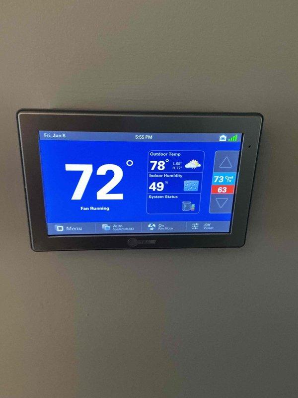 Completed comprehensive BFMA tune-up on 4-year-old air conditioning system, including full system diagnostics and performance verification. Measured electrical parameters using digital multimeter, confirming proper voltage and amperage readings at 229.9V, and verified thermostat operation showing system cooling to 72°F setpoint with indoor humidity at 49%. Performed air cleaner semi-annual filter change service and established recurring maintenance schedule for continued system reliability.