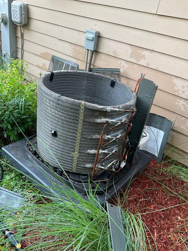 Completed comprehensive BFMA tune-up service on residential air conditioning system aged 5+ years. Performed standard maintenance inspection and documented significant condenser coil deterioration with heavy corrosion, compressed fins, and structural compromise throughout the coil assembly, indicating severely reduced efficiency and potential system failure. Inspected and verified indoor air filtration system, noting clean filter media in acceptable condition within housing assembly.