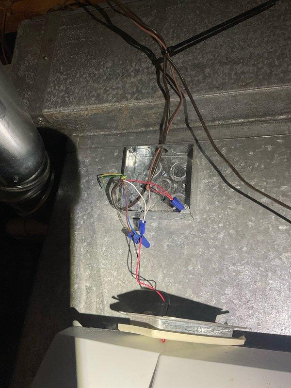 Responded to after hours service call for Generac transfer switch system inspection. Upon arrival, documented existing electrical installation mounted on exterior brick wall showing transfer switch control panel with multiple indicator lights and wire connections. Observed wiring configuration with various colored conductors (red, white, blue, yellow, orange, black, brown) routed through the system, some bundled with zip ties. Noted junction box installation on ceiling with visible wire connections secured with wire nuts. Photographed current state of equipment including control panel data plate, electrical connections, and associated components for service records. System components included transfer switch panel, cylindrical capacitor, and related electrical equipment. All observations documented for follow-up service recommendations.