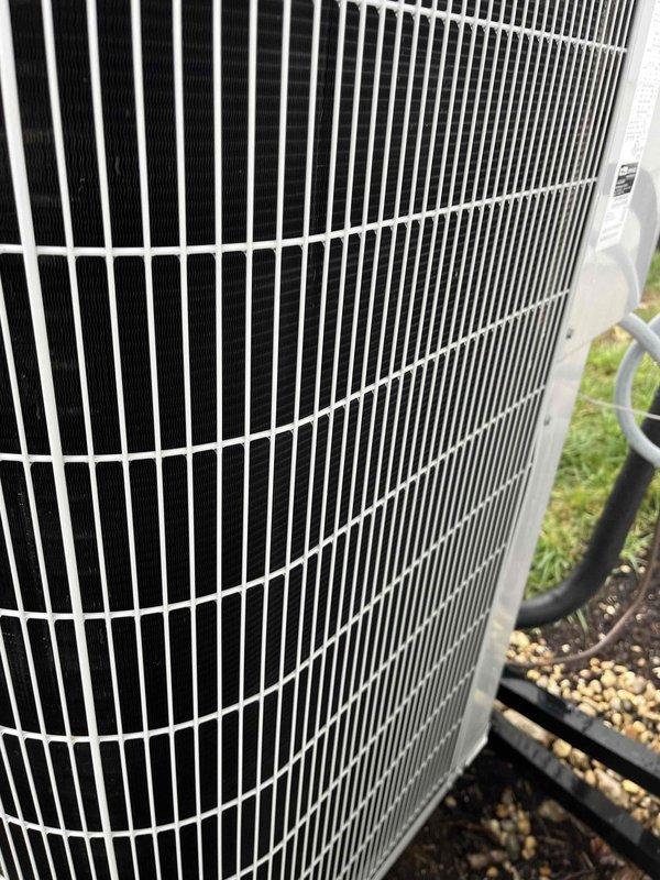 Completed comprehensive BFMA tune-up on residential outdoor air conditioning condenser unit. Performed standard preventive maintenance protocol including inspection of cylindrical protective grille assembly, vertical condenser fins, refrigerant lines, and electrical conduit. Unit found in good operating condition with clean coils, no visible damage or deterioration, and all components functioning within normal parameters.