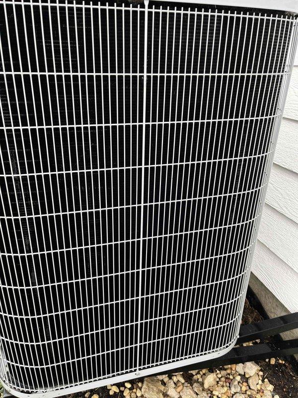 Completed comprehensive BFMA tune-up on residential outdoor air conditioning condenser unit. Performed standard preventive maintenance protocol including inspection of cylindrical protective grille assembly, vertical condenser fins, refrigerant lines, and electrical conduit. Unit found in good operating condition with clean coils, no visible damage or deterioration, and all components functioning within normal parameters.