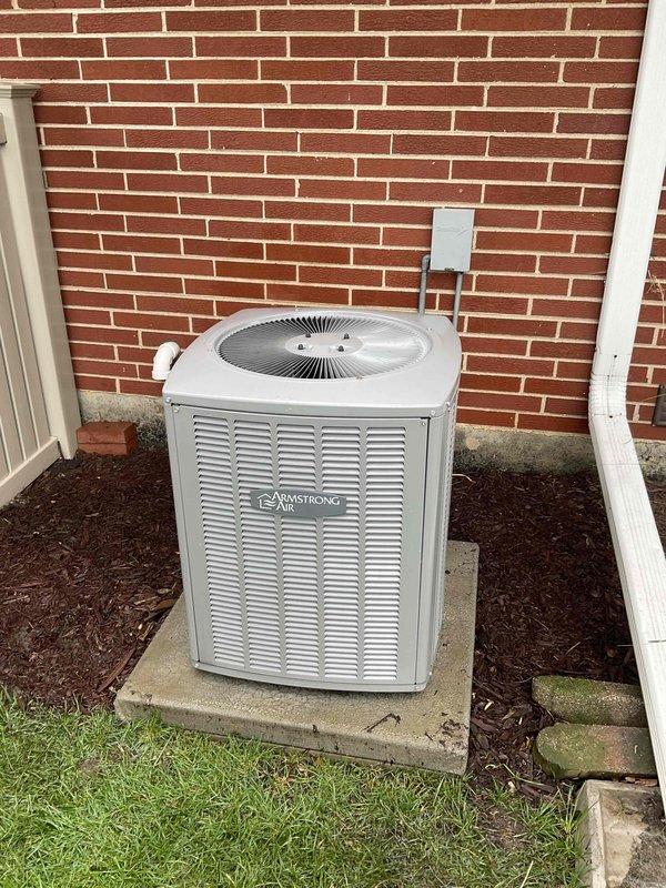 Completed comprehensive BFMA tune-up on 4+ year old Armstrong air conditioning system during morning service window. Performed standard maintenance protocol including inspection of outdoor condensing unit, evaporator coil assessment revealing significant dust and debris accumulation on coil fins requiring attention, and filter replacement. Collected membership payment via check as requested and documented equipment condition with photos showing condensing unit positioned on concrete pad with proper clearances and heavily soiled evaporator coil with white-gray particulate buildup affecting airflow efficiency.