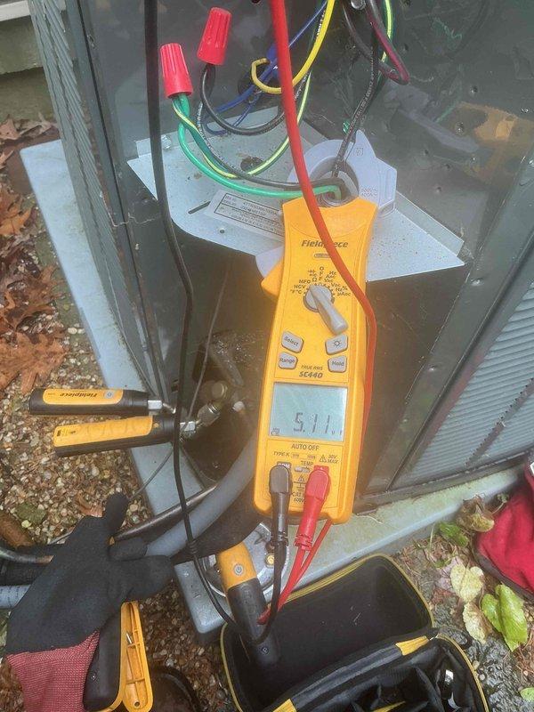 Completed comprehensive BFMA tune-up on 2-year-old Trane XR outdoor condensing unit. Performed electrical diagnostics using digital multimeter, verified proper voltage readings at control connections, inspected and tested all wire terminations with appropriate wire nut connections. Cleaned accumulated debris, pine needles, and organic growth from unit top and exterior surfaces to ensure proper airflow and prevent premature corrosion.