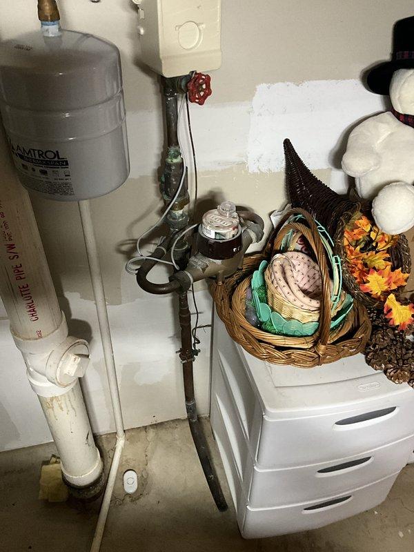 Responded to service call for reported plumbing and sump pump issues. Upon inspection of basement utility area, evaluated all visible plumbing components including water treatment system, supply lines, and drainage systems. Examined water heater connections, pressure relief valve, and associated copper and PVC piping for proper operation. Inspected sump pump system and verified functionality of discharge lines and check valves. All plumbing systems found to be operating within normal parameters with no immediate concerns identified.