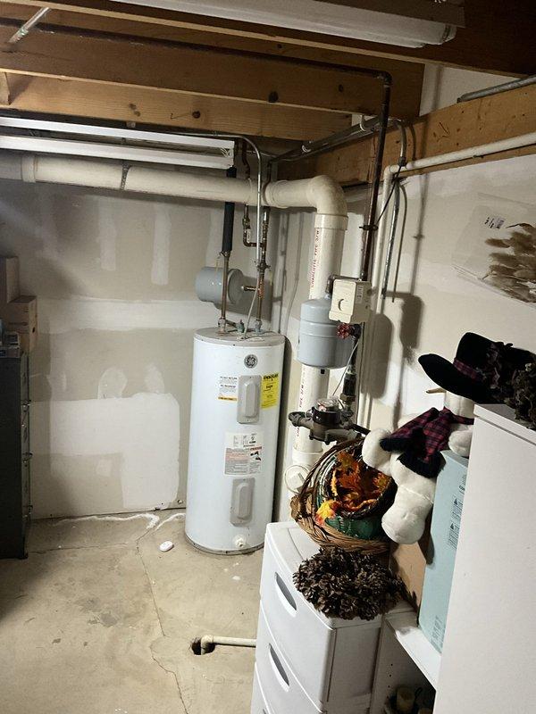 Responded to service call for reported plumbing and sump pump issues. Upon inspection of basement utility area, evaluated all visible plumbing components including water treatment system, supply lines, and drainage systems. Examined water heater connections, pressure relief valve, and associated copper and PVC piping for proper operation. Inspected sump pump system and verified functionality of discharge lines and check valves. All plumbing systems found to be operating within normal parameters with no immediate concerns identified.
