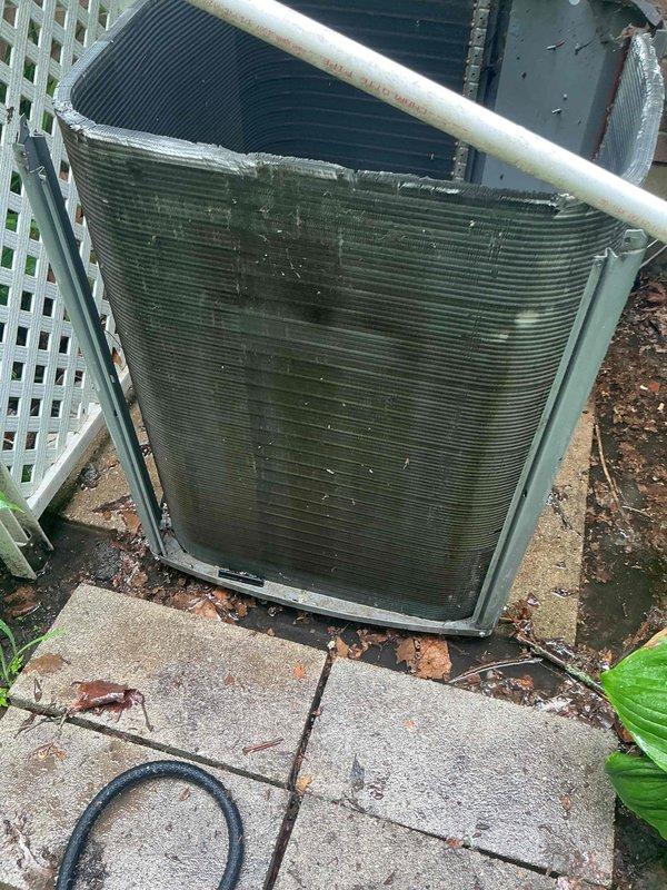 Completed comprehensive AC tune-up on 9+ year old outdoor condenser unit. Removed heavy accumulation of organic debris, decomposed leaves, and dirt from unit base, coils, and surrounding concrete pad. Cleaned condenser coils, inspected refrigerant lines, verified proper airflow through fins, and ensured unit operational efficiency following standard BFMA maintenance protocols.