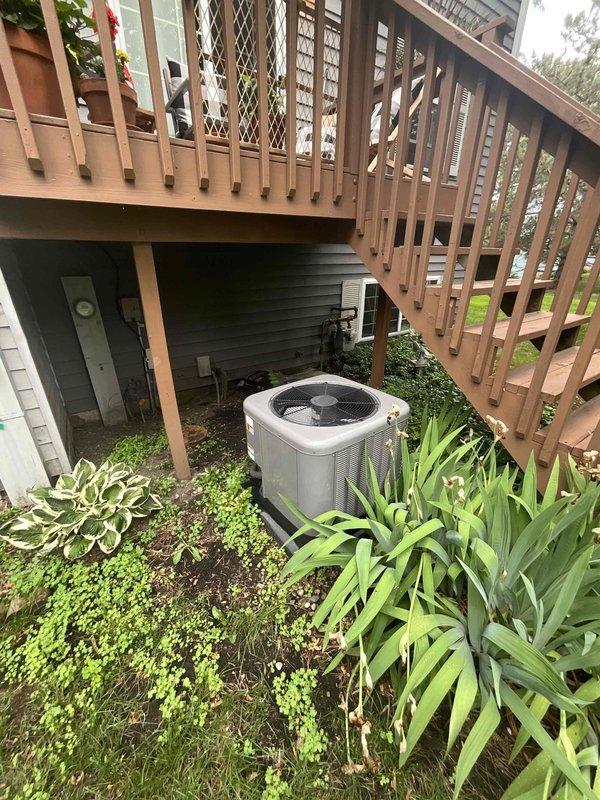 Conducted comprehensive sales estimate for air conditioning system and evaporator coil replacement at residential property. Evaluated existing outdoor condensing unit located beneath elevated wooden deck structure and assessed electrical panel configuration to determine compatibility requirements for new equipment installation. Documented current system placement, electrical infrastructure including circuit breaker panel with multiple circuits, and site-specific installation considerations including deck clearance, landscaping proximity, and access constraints for future equipment replacement.