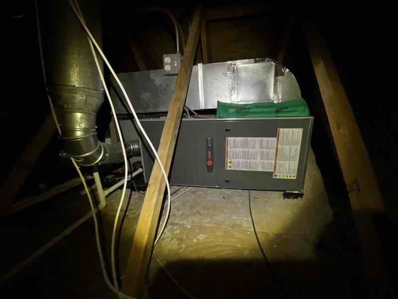 Completed comprehensive BFMA tune-up service on attic-mounted HVAC system, performing dual AC tune-up procedures and filter replacement as part of preventative maintenance contract. Inspected and serviced blower motor assembly and squirrel cage fan, verified proper electrical connections, examined ductwork connections, and confirmed all components operating within manufacturer specifications. Unit found in good working condition with no deficiencies noted during inspection.