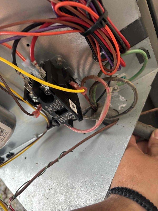 Responded to service call for HVAC condenser unit not firing on approximately 1-year-old residential system. Upon arrival, accessed control panel and electrical compartment to diagnose issue. Inspected contactor, relay, capacitors, and associated wiring connections within the control housing. Examined exterior electrical disconnect, conduit routing, and weatherproof junction boxes mounted on building exterior adjacent to condensing unit. Verified proper electrical connections, tested components, and restored system to operational status.