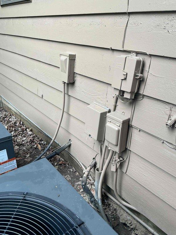 Responded to service call for HVAC condenser unit not firing on approximately 1-year-old residential system. Upon arrival, accessed control panel and electrical compartment to diagnose issue. Inspected contactor, relay, capacitors, and associated wiring connections within the control housing. Examined exterior electrical disconnect, conduit routing, and weatherproof junction boxes mounted on building exterior adjacent to condensing unit. Verified proper electrical connections, tested components, and restored system to operational status.