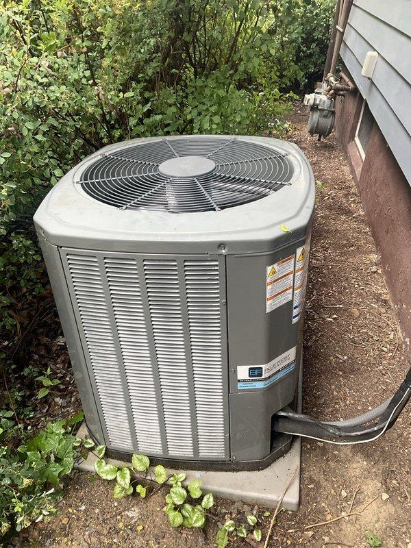 Completed comprehensive tune-up service on 14+ year old residential air conditioning system during morning appointment. Performed full system inspection of outdoor condenser unit, including evaluation of coil condition, refrigerant lines, electrical connections, and overall equipment operation. Documented equipment condition with photos showing outdoor condenser unit positioned on concrete pad with proper drainage, copper coil assembly displaying age-appropriate patina, and fin configuration maintaining structural integrity despite normal weathering from outdoor exposure.