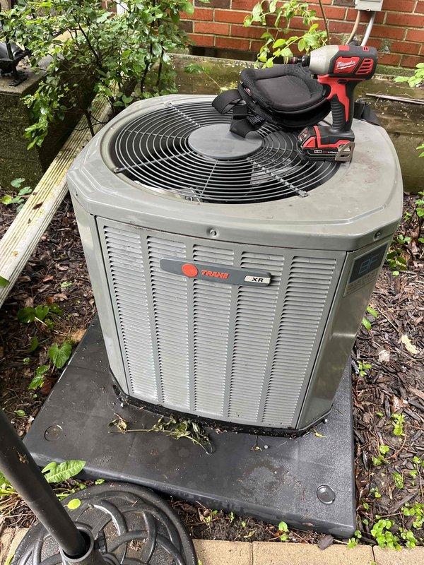Responded to service call for non-operational air conditioning system and performed comprehensive BFMA tune-up on Trane XR condensing unit. Conducted thorough inspection of 4+ year old equipment, identifying significant debris accumulation and fibrous material buildup within condenser coils that was restricting airflow and reducing system efficiency. Cleaned heat exchanger coils to restore proper heat transfer capability, inspected copper refrigerant lines showing surface oxidation but maintaining structural integrity, verified fan operation and electrical connections, and tested system performance. Unit restored to proper working condition with improved airflow through coil assembly, ensuring optimal cooling capacity for continued operation.