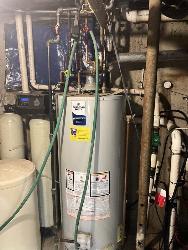 Responded to service call for non-operational sump pump with concerns about potential basement flooding. Upon inspection, diagnosed and resolved the issue to restore proper sump pump functionality. Verified discharge lines exterior to foundation were clear and properly positioned, and confirmed all mechanical room plumbing systems including water heater connections were operating correctly to prevent water backup and protect the home from flooding damage.