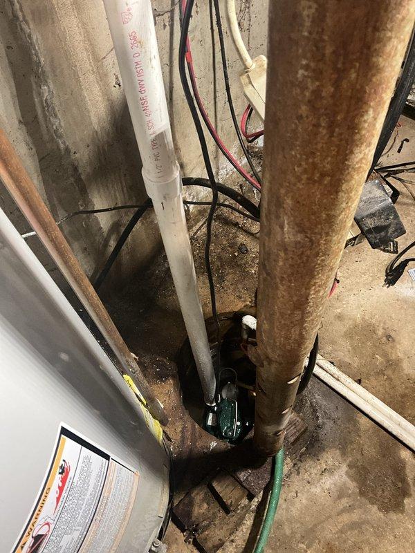Installed new 1/2 horsepower primary sump pump in basement mechanical room. Removed redundant 1-1/2" check valve from interior discharge line after confirming presence of existing check valve on exterior discharge near air conditioning unit to prevent double-check valve configuration. New pump installation includes 3-year manufacturer warranty on equipment and 1-year labor warranty.