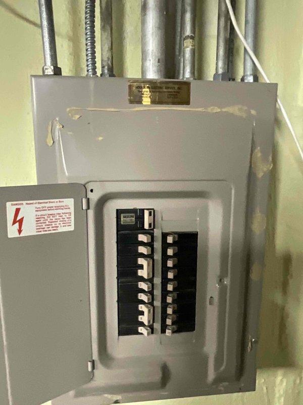 Conducted sales estimate for air conditioning system replacement on property with multiple HVAC units. Customer requested evaluation and proposal for replacing aging AC unit. Documented existing electrical service panel and circuit breaker configuration to assess compatibility with new equipment installation requirements.