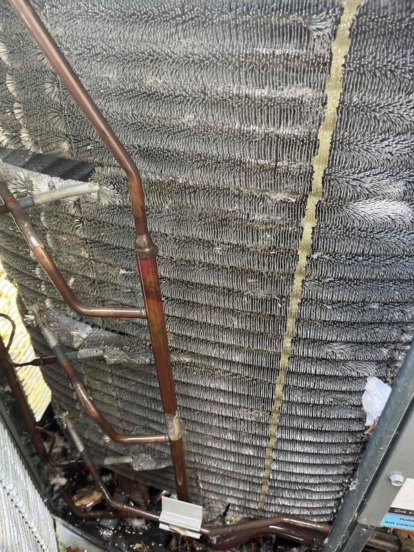 Completed comprehensive BFMA tune-up on 8+ year old residential air conditioning system. Performed thorough inspection of outdoor condenser unit and indoor evaporator coil assembly, noting heavy dirt and debris accumulation on coil fins and copper refrigerant lines showing normal oxidation. Cleaned condenser coils, checked refrigerant levels, tested electrical components, verified proper airflow through louvers, and ensured unit operational efficiency. System returned to proper working condition with improved performance following standard maintenance protocol.