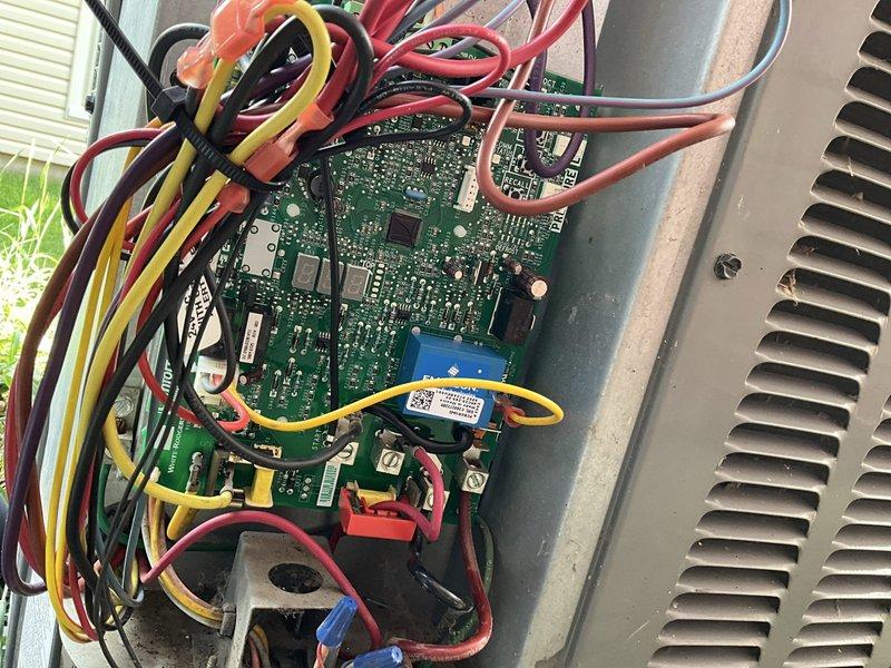Replaced defective control board in outdoor AC unit and installed hard start kit to improve compressor performance. The new circuit board was staged at headquarters and successfully installed with all wire harnesses properly connected to terminals. Hard start kit with SUPCO capacitor was mounted and wired to assist compressor on startup, reducing electrical draw and extending equipment lifespan.