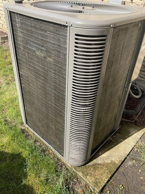 Completed comprehensive air conditioning tune-up on outdoor condensing unit aged 2+ years. Performed full system inspection including checking refrigerant levels, cleaning condenser coils, testing electrical connections, verifying proper airflow through grilles and fan operation, and ensuring unit was operating efficiently on concrete pad. All components found to be functioning within normal parameters, and system was left in optimal working condition for continued cooling performance.