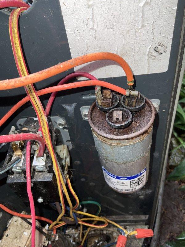 Completed comprehensive air conditioning tune-up on 14-year-old outdoor condensing unit. Performed standard maintenance protocol including inspection of all electrical components, capacitor testing, contactor evaluation, and system performance verification. Notable findings included moderate rust and corrosion observed on capacitor casing and terminal connections, though unit remained operational within acceptable parameters at time of service.
