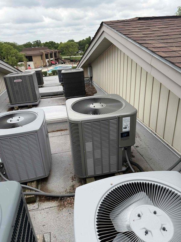 Performed comprehensive BFMA tune-up on rooftop air conditioning unit at multi-unit residential facility. Accessed RTU via ladder and completed full system inspection of one of multiple condenser units installed on flat roof. Inspected heat exchanger fins which showed significant dust and debris accumulation, along with organic material buildup at base of unit. Evaluated condenser coil condition, checked refrigerant levels, tested electrical connections, and verified proper operation of all mechanical components. Cleaned accumulated dirt and debris from exterior surfaces and surrounding area. Confirmed unit operational status and documented existing equipment condition with photographic evidence showing typical wear for equipment age and outdoor exposure.