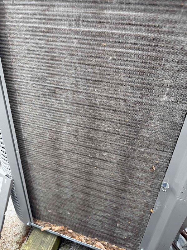 Performed comprehensive BFMA tune-up on rooftop air conditioning unit at multi-unit residential facility. Accessed RTU via ladder and completed full system inspection of one of multiple condenser units installed on flat roof. Inspected heat exchanger fins which showed significant dust and debris accumulation, along with organic material buildup at base of unit. Evaluated condenser coil condition, checked refrigerant levels, tested electrical connections, and verified proper operation of all mechanical components. Cleaned accumulated dirt and debris from exterior surfaces and surrounding area. Confirmed unit operational status and documented existing equipment condition with photographic evidence showing typical wear for equipment age and outdoor exposure.