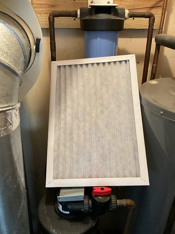 Completed comprehensive BFMA tune-up on a 21+ year old residential air conditioning system during afternoon service window. Performed standard maintenance protocol on outdoor condenser unit including inspection of compressor operation, refrigerant level verification, electrical connection evaluation, and coil cleaning of the cylindrical finned condenser positioned on weathered concrete pad. Inspected and serviced indoor air handler components including pleated air filter assessment, ductwork connections, and associated mechanical systems with water filtration equipment and copper piping infrastructure. All system components tested and confirmed operational following tune-up procedures, with equipment running within acceptable parameters despite advanced age of unit.