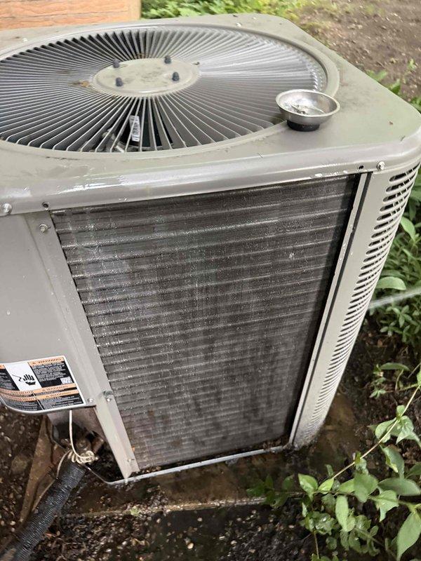 Performed comprehensive air conditioning tune-up on outdoor condenser unit and indoor heating coil system. Inspected condenser unit exterior, noting accumulation of dirt and debris on heat exchanger fins; cleaned and serviced unit to restore optimal airflow and efficiency. Evaluated indoor evaporator coil condition, which showed dust buildup on vertical fins, and performed necessary cleaning and maintenance procedures. Verified all electrical connections, tested capacitor function, confirmed proper refrigerant levels, and ensured system operational parameters met manufacturer specifications for continued reliable performance.