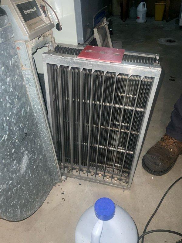 Performed comprehensive air conditioning tune-up on outdoor condenser unit and indoor heating coil system. Inspected condenser unit exterior, noting accumulation of dirt and debris on heat exchanger fins; cleaned and serviced unit to restore optimal airflow and efficiency. Evaluated indoor evaporator coil condition, which showed dust buildup on vertical fins, and performed necessary cleaning and maintenance procedures. Verified all electrical connections, tested capacitor function, confirmed proper refrigerant levels, and ensured system operational parameters met manufacturer specifications for continued reliable performance.