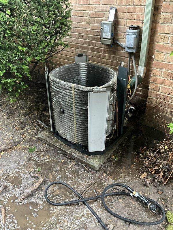 Completed comprehensive BFMA tune-up service on a 7-year-old outdoor condensing unit. Performed standard maintenance procedures including inspection of the heat exchanger coil with horizontal fins, blower fan assembly, and electrical components. Unit was found to be operating within normal parameters, with all safety labels intact and equipment properly secured on concrete pad foundation.