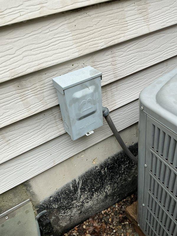Responded to no cooling call at residential property. Upon arrival, verified system was not cooling and instructed client to turn unit off or run fan only to prevent further damage. Inspected outdoor condensing unit and electrical disconnect box. Documented existing conditions including visible staining on building exterior and foundation near equipment location for service records.