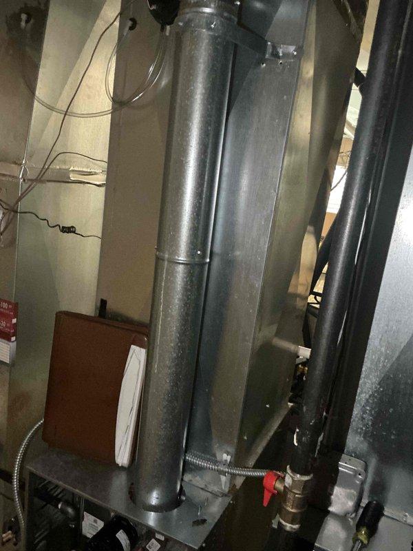 Completed comprehensive AC replacement estimate for residential HVAC system. Documented existing air handler unit and associated ductwork configuration in basement utility area, including current plenum connections, refrigerant line routing with shut-off valves, and condensate drainage system. Assessed equipment access, clearances, and electrical service provisions for new coil and air conditioning system installation. Photographed existing furnace integration points and duct transitions to ensure proper sizing and compatibility specifications for replacement equipment proposal.